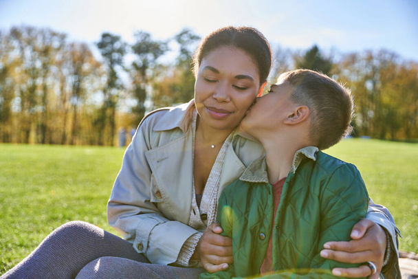 bonding and love, son kissing cheek of mother, happy african american woman and boy, fall - Photo, image
