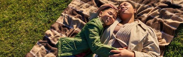 top view, happiness, motherly love, african american woman and son lying on blanket, autumn, banner - Photo, Image