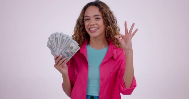 Woman, okay sign and money bonus, finance success or winning, university loan and emoji in studio. Face of person or gen z winner and yes for cash fan, deal or prize and reward on white background. - Séquence, vidéo
