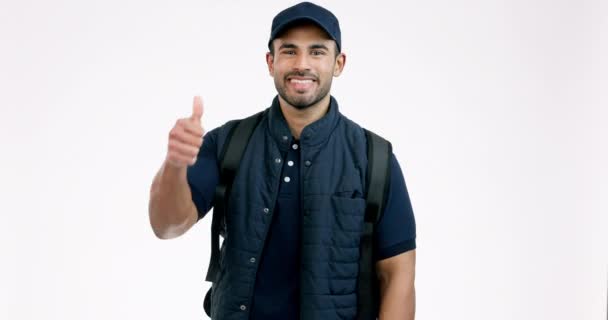 Happy man, delivery bag and thumbs up in success, thank you or approval against a grey studio background. Portrait of male person or courier guy smile with like emoji, yes sign or OK for supply chain. - Footage, Video