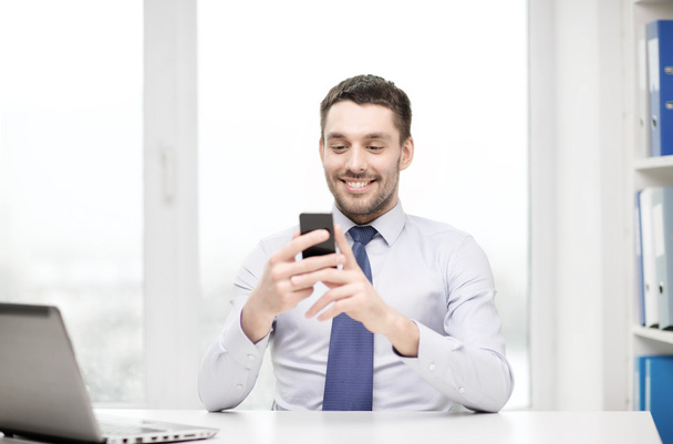 Businessman with laptop and smartphone - Φωτογραφία, εικόνα