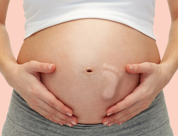 pregnant woman touching   tummy - 写真・画像