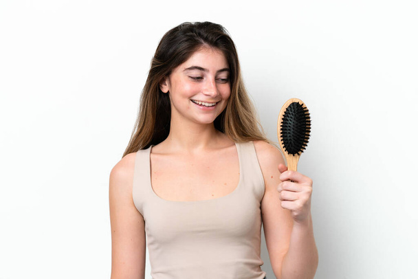 Young woman with hair comb isolated on white background with happy expression - Photo, Image