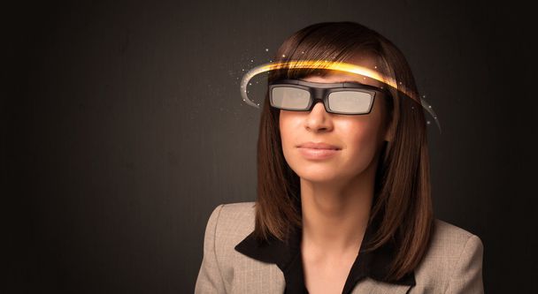 Pretty woman looking with futuristic high tech glasses  - Photo, image