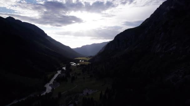 Beautiful sunset with a view of the green gorge and the river. coniferous trees, forests, lots of grass are all around. A seething gray river. Clouds in the sky. The rays of the sun. Steep cliffs - Footage, Video
