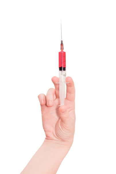 Medical syringe with medicine in hand, isolated on white  - Fotó, kép