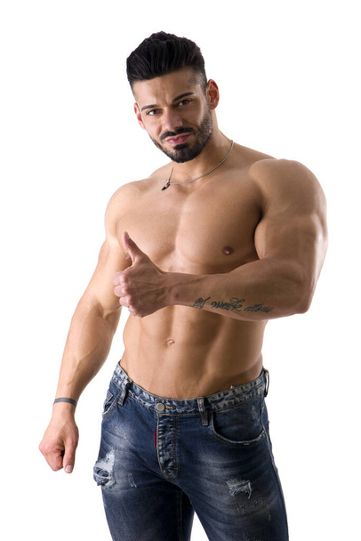 A shirtless man posing for the camera doing thumb up gesture for OK or approval - Foto, afbeelding