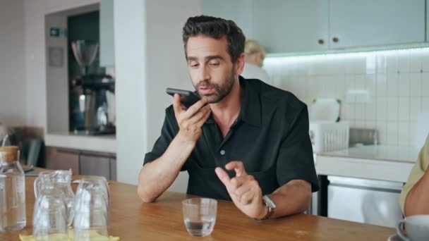 Επιχειρηματίας καταγραφή φωνητικού ταχυδρομείου στο smartphone κάθεται ζεστό μικρό εστιατόριο κοντά. Όμορφος άντρας στέλνει ηχητικό μήνυμα στο κινητό. Γενειοφόρος ελεύθερος επαγγελματίας υπαγορεύει αίτημα σε βοηθό αίτηση. - Πλάνα, βίντεο