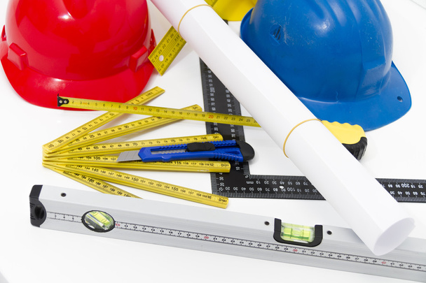 Colorful helmets and tools for construction drawings and buildin - Photo, Image