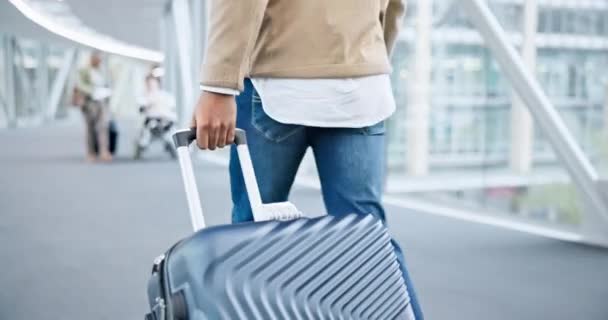 Back, walking and hands on suitcase in airport to travel, vacation or holiday in airline lobby. Luggage, person and rear of man on flight terminal, immigration journey or international airplane trip. - Footage, Video