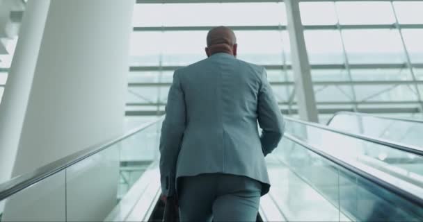 Escalator, office and back of business man on commute, travel and arrival for corporate career, job or work. Professional, modern workplace and person on electric stairs in lobby, airport or terminal. - Footage, Video