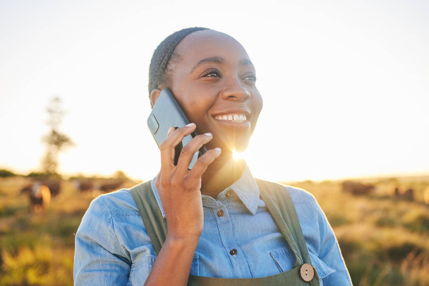 Phone call, countryside and black woman with a smile, agriculture and communication with network. Person outdoor, girl or farmer with a smartphone, conversation and connection with nature and contact. - Photo, Image