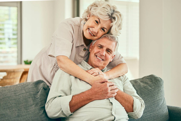 Portrait, smile or old couple hug in house living room bonding together to relax on holiday for love. Support, happy or senior man in retirement with a mature woman with trust or care in marriage. - Photo, Image