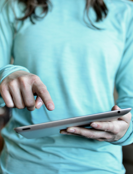 Mulher segurando Tablet e usando o dedo
 - Foto, Imagem