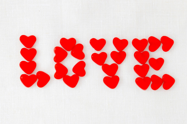 Red jelly beans candy for Valentine's day. Inscription love  - 写真・画像