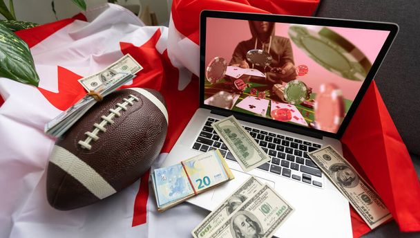 Man betting on sports using laptop at table, closeup. Bookmaker website on screen. High quality photo - Photo, Image