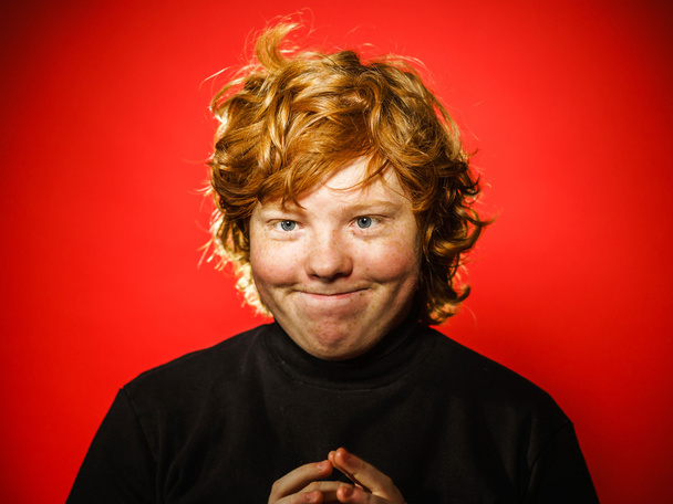 Expressive red-haired teenage boy showing emotions in studio - Photo, image