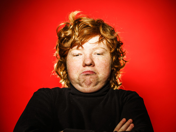 Expressive red-haired teenage boy showing emotions in studio - Foto, Imagem