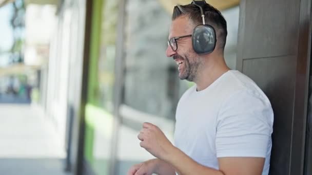 Homem de cabelos grisalhos ouvindo música e dançando na rua - Filmagem, Vídeo