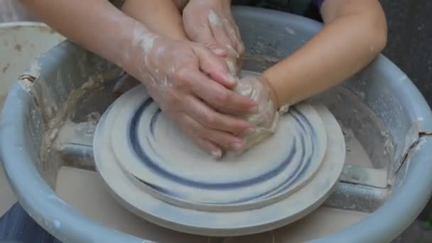 Close-up tiro de meia-acabado vaso de cerâmica girando na roda de cerâmica e mãos moldando argila com ferramentas profissionais. Criando utensílios e conceito de cerâmica tradicional
. - Filmagem, Vídeo