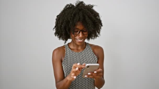 African american woman business worker smiling confident using smartphone over isolated white background - Footage, Video