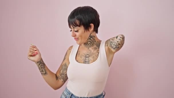 Mulher hispânica com braço amputado sorrindo dança confiante sobre fundo rosa isolado - Filmagem, Vídeo