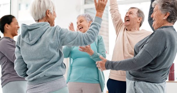 Fitness, hands together and senior people for exercise support, celebration and teamwork in workout class. Exercise, training goal and group of elderly man and women with high five for health success. - Photo, Image