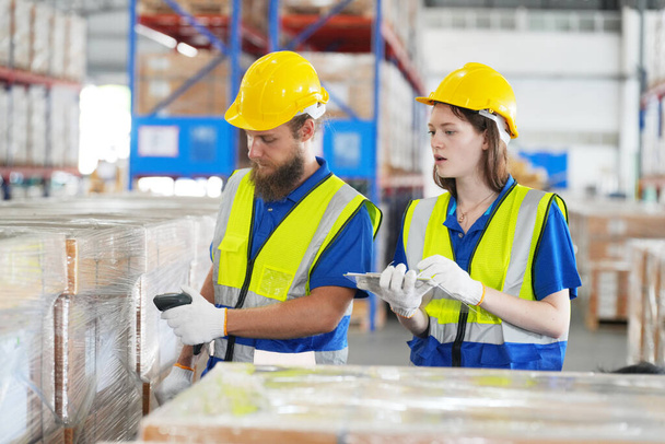 Warehouse Industrial supply chain and Logistics Companies inside. Warehouse workers checking the inventory. Products on inventory shelves storage. Worker Doing Inventory in Warehouse. - Photo, Image