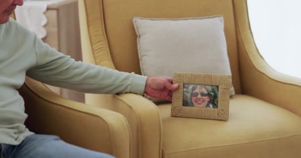 Photo, frame and man sad with past memory and chair of dead woman, wife or lady in living room, lounge or nursing home. Grief, loss or picture of person on sofa or couch to honor death and life. - Footage, Video