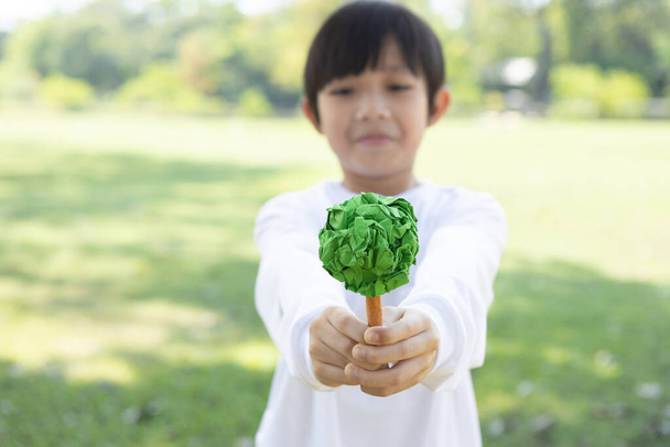 Niño asiático sosteniendo árbol de papel reciclado para promover el estilo de vida ecológico en la reducción, reutilización, y el fomento de la conciencia ambiental con la reforestación para la generación futura y sostenible Tierra más verde. Gyre. - Foto, Imagen