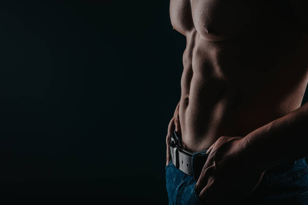 Silhouette photo of man showing his six pack. Man showing abs, copy space. - Photo, Image