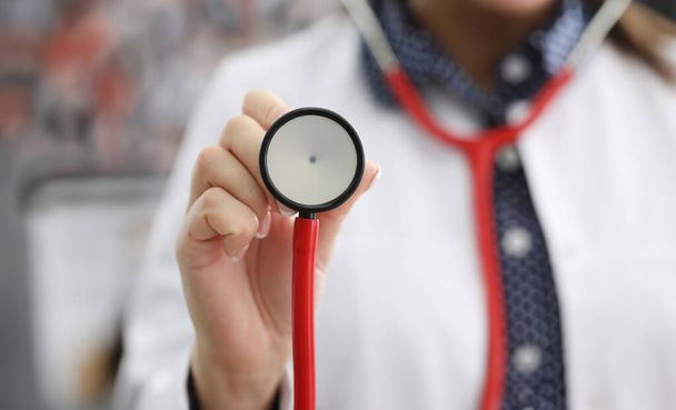 Doctor in white coat shows stethoscope membrane. Poor environmental conditions and stress affect health. Universal doctor who specializes in studying occurrence diseases internal organs - Photo, Image