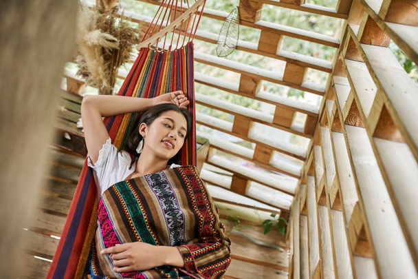 women retreat concept, happy young woman relaxing in hammock in cottage, top view - Photo, Image
