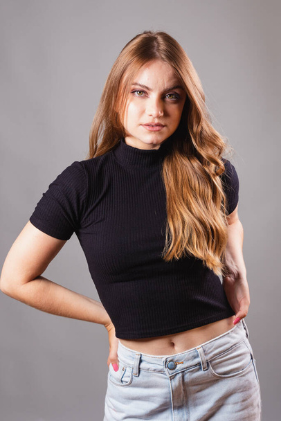Beautiful blonde, Brazilian woman wearing black shirt. in vertical portrait, model, facing camera. - Foto, Imagen
