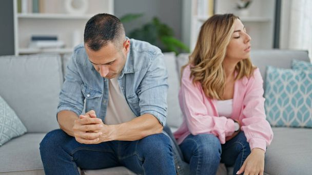 Man and woman angry couple sitting on sofa together at home - Photo, Image