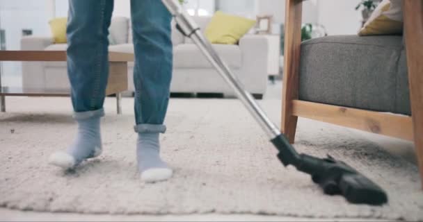 Feet, carpet and vacuum cleaner for spring cleaning in a home with a person in the living room closeup. Floor, appliance and equipment with an adult in an apartment for housework or housekeeping. - Footage, Video