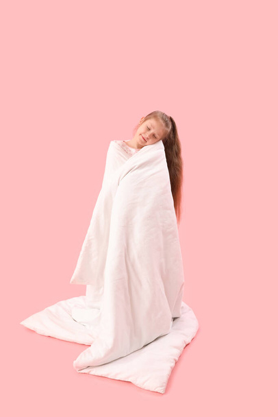 Little girl with soft blanket on pink background - Photo, Image
