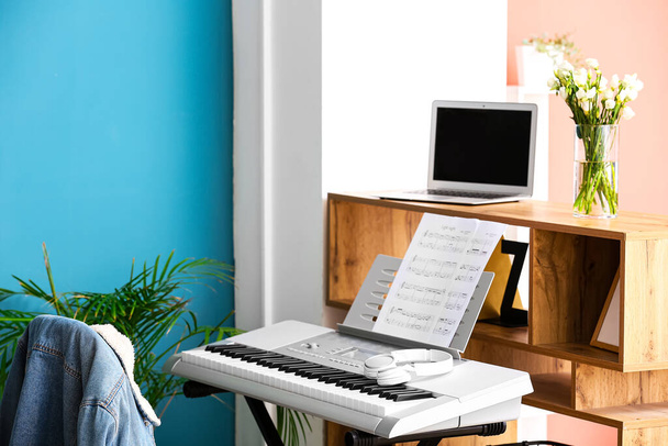 Modern synthesizer and chair in room, closeup - Photo, Image