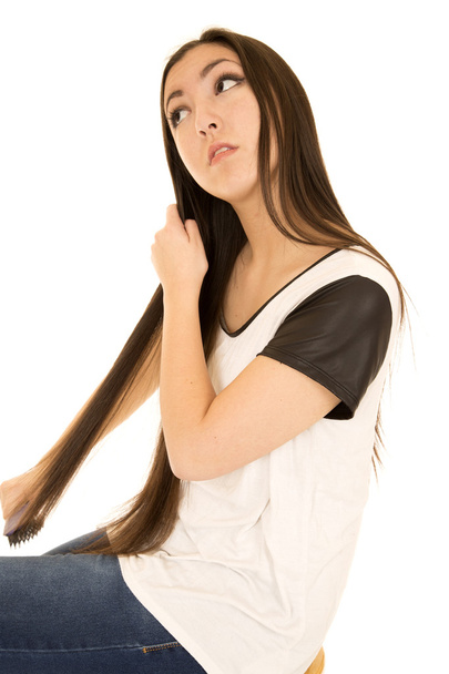 Asian American teen brushing her long dark hair - Photo, image