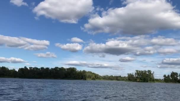Cumulus clouds over the lake in Ukraine in sunny summer day - Footage, Video