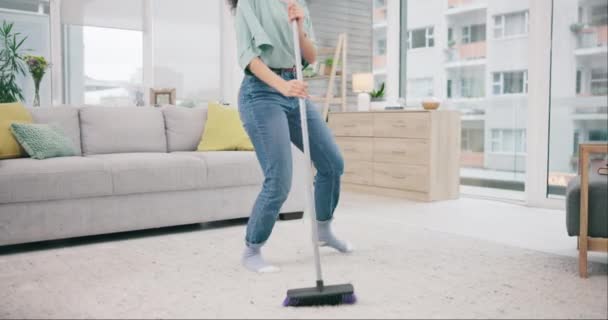 Music, legs and woman dance, cleaning and sweeping dust in home living room. Radio, broom and person listening to audio, sound and moving to podcast energy with hands for housework, chores or hygiene. - Footage, Video