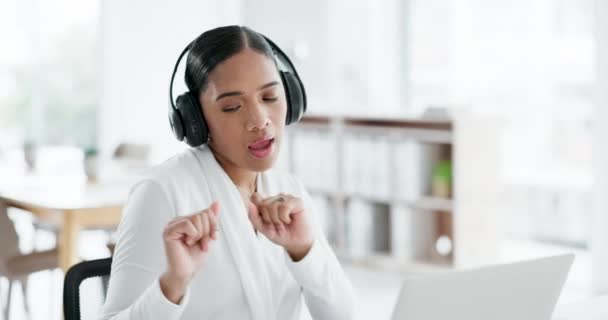 Business woman, headphones and dancing with laptop, comic laugh or excited celebration for success at startup. Entrepreneur, computer and happy for music, singing or win with streaming subscription. - Footage, Video