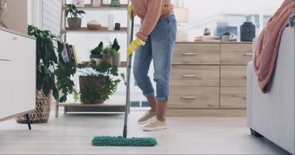 Person, mopping and cleaning living room floor in house hygiene, dirt and bacteria safety in housekeeping routine. Wipe, cleaner or equipment for ground dust control, disinfection or germs protection. - Footage, Video