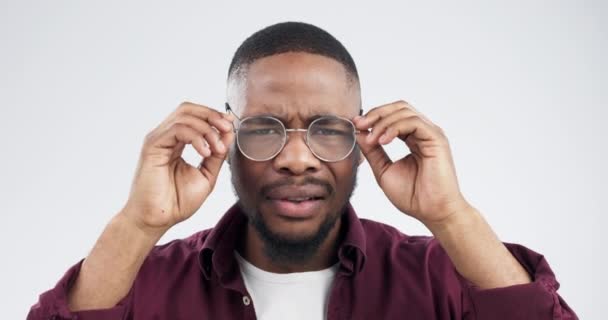 Confused, face and black man in studio with glasses for reading news, promo or info on grey background. Wtf, portrait and African male model with doubt for gossip, drama or coming soon quote offer. - Footage, Video