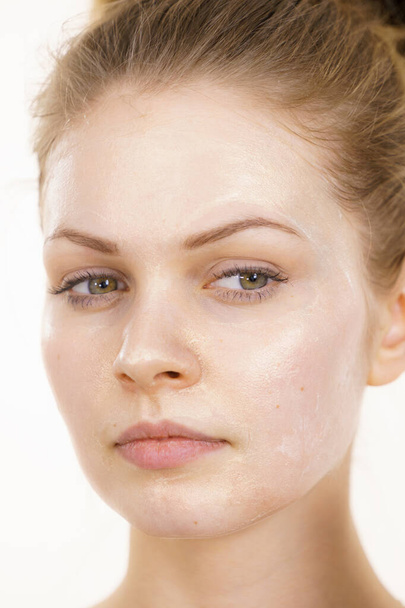 Young woman with cream cosmetic, mask moisture on her face. Beauty treatment. Skincare. - Valokuva, kuva