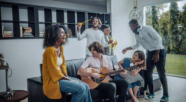 Vibrant multicultural reunion of friends, filled with laughter, diverse stories, exciting interaction. A blend of togetherness, bonding, celebration, where music, dance, chat create joyful atmosphere - Fotoğraf, Görsel