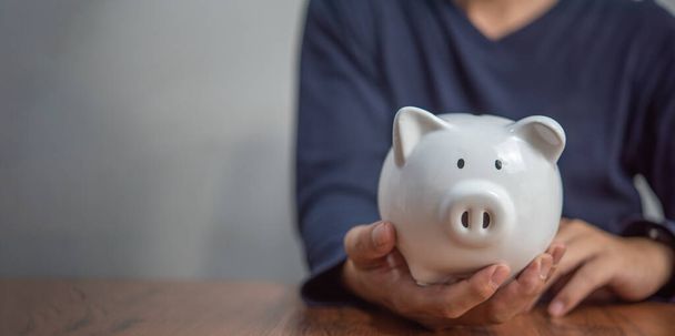 Man hand holding piggy bank. Business financial and banking investment ,saving money concept. - Photo, Image