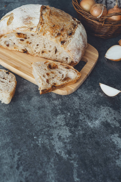 Homemade whole wheat onion bread for sandwiches or toasting concrete background. Caramelized onion sourdough bread. Healthy organic food. High quality photo - Photo, Image