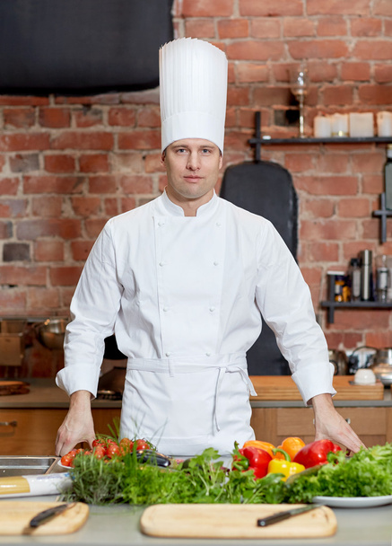 happy male chef cook with vegetables in kitchen - Foto, imagen