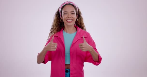 Happy woman, thumbs up and winning in success, thank you or good job against a studio background. Portrait of female person smile with like emoji, yes sign or OK in approval or agree on mockup space. - Footage, Video